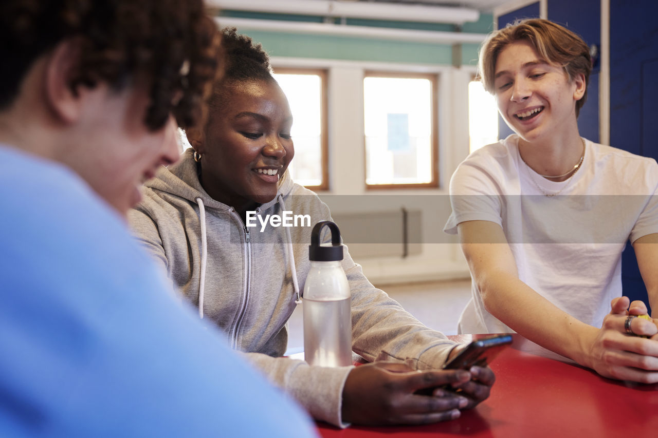 Teenagers talking in locker room