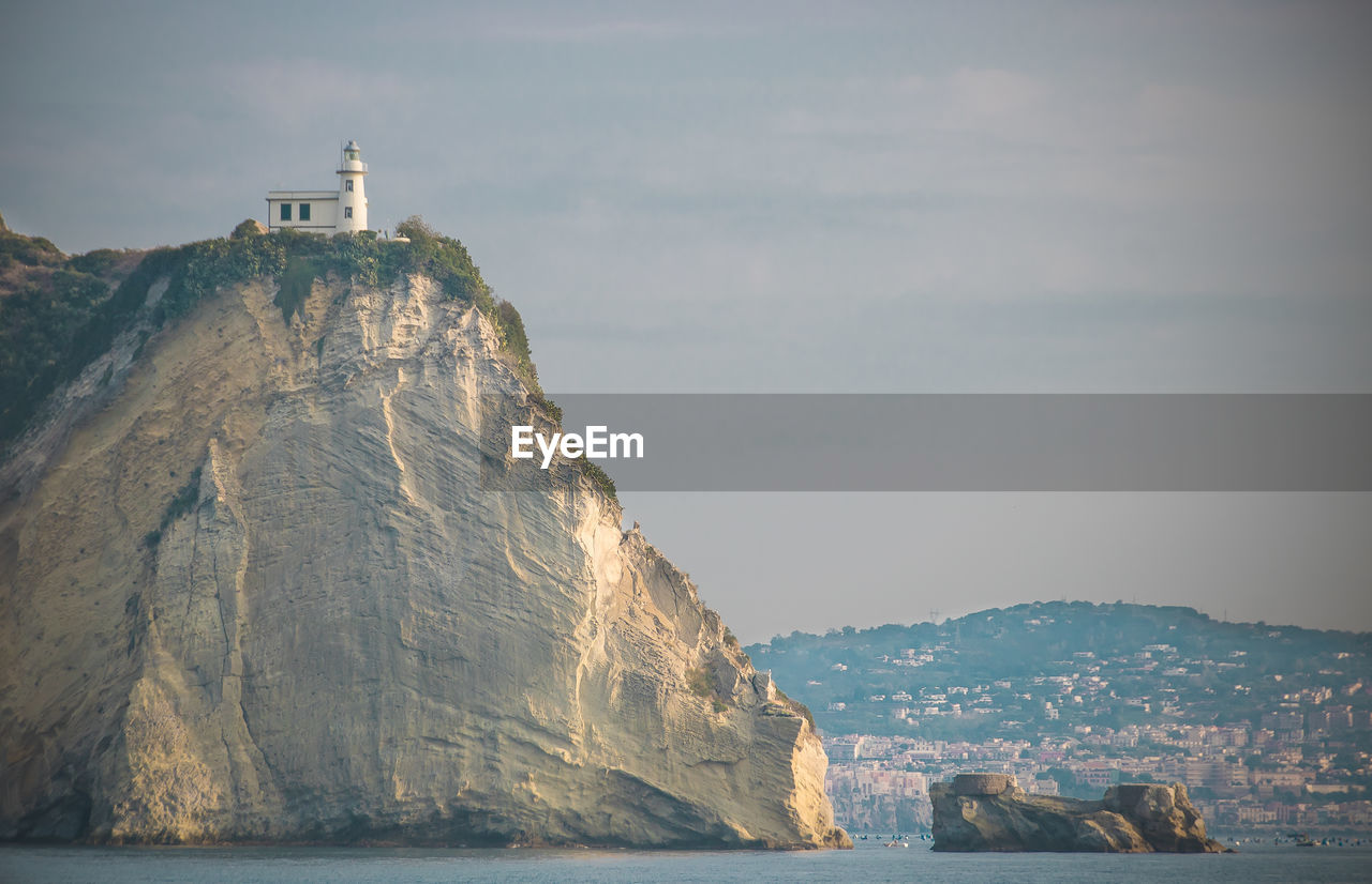 Low angle view of building on rock formation