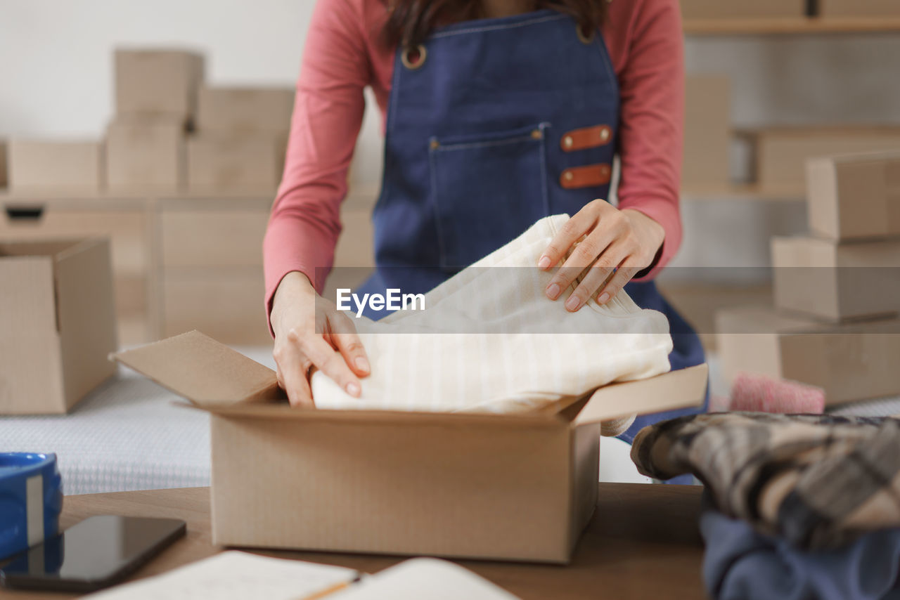 midsection of man working in box