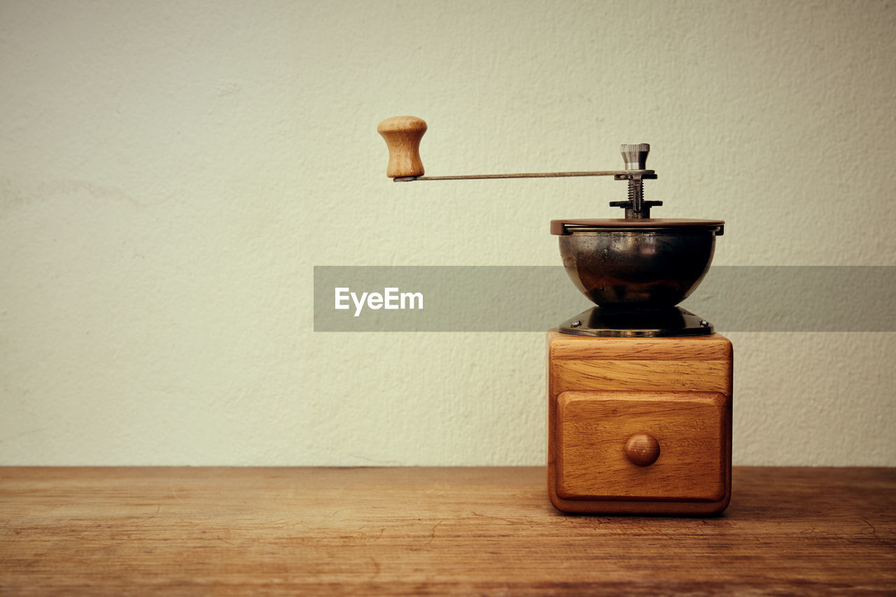 Coffee grinder on table at home