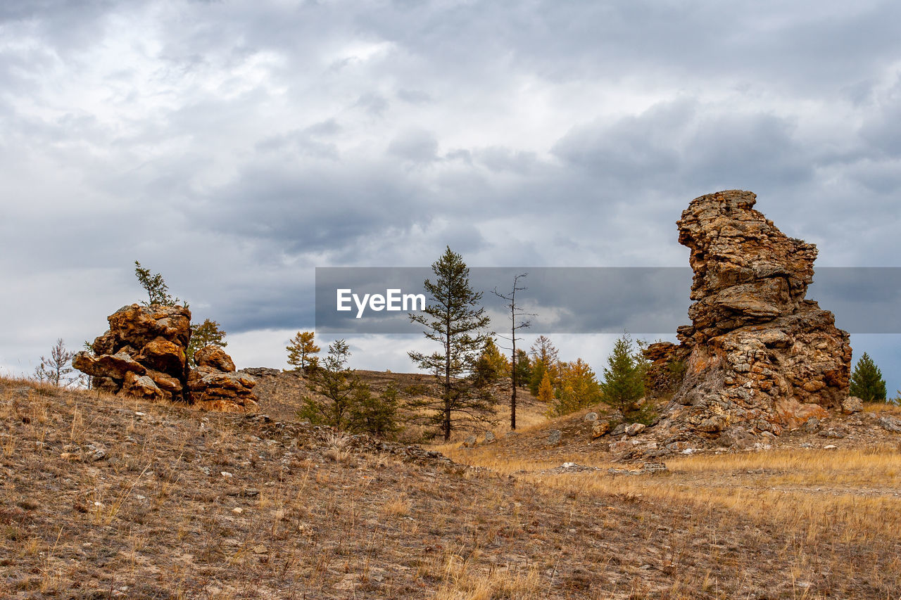 ROCKS ON LAND AGAINST SKY