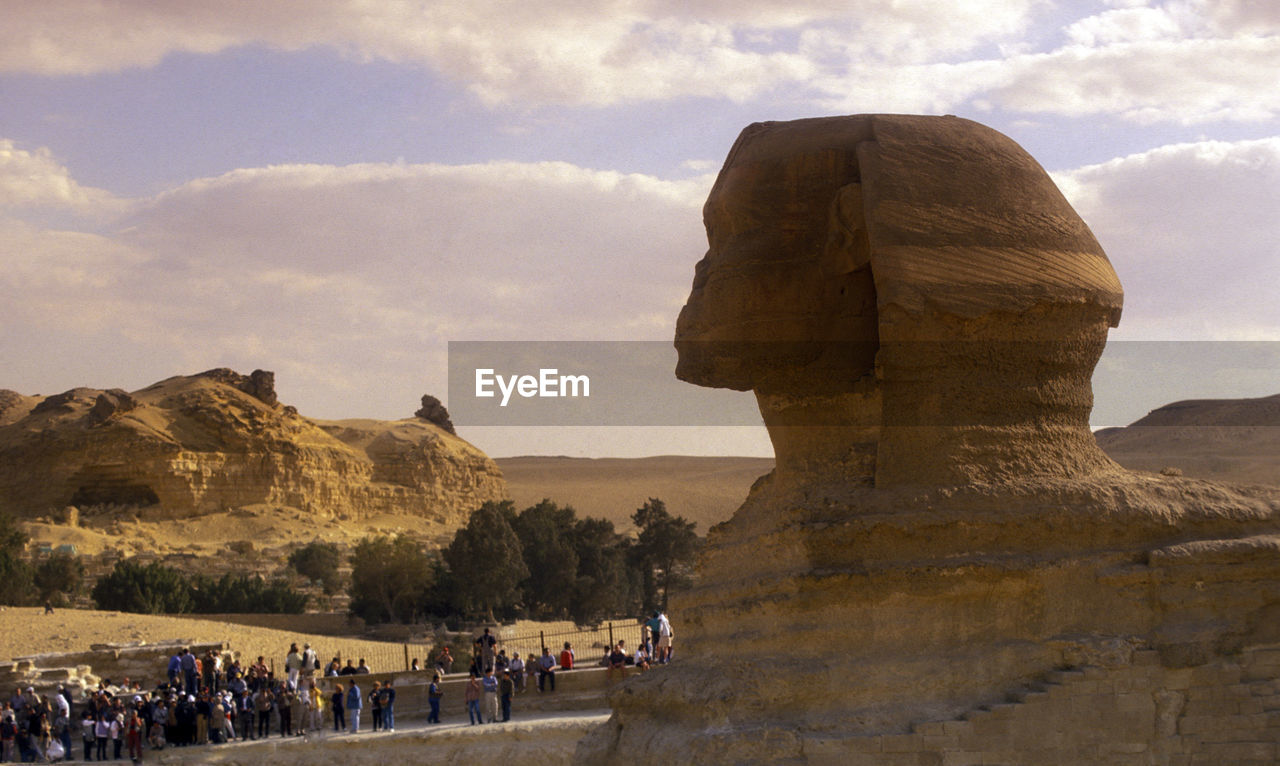 Tourists visiting the sphinx against sky