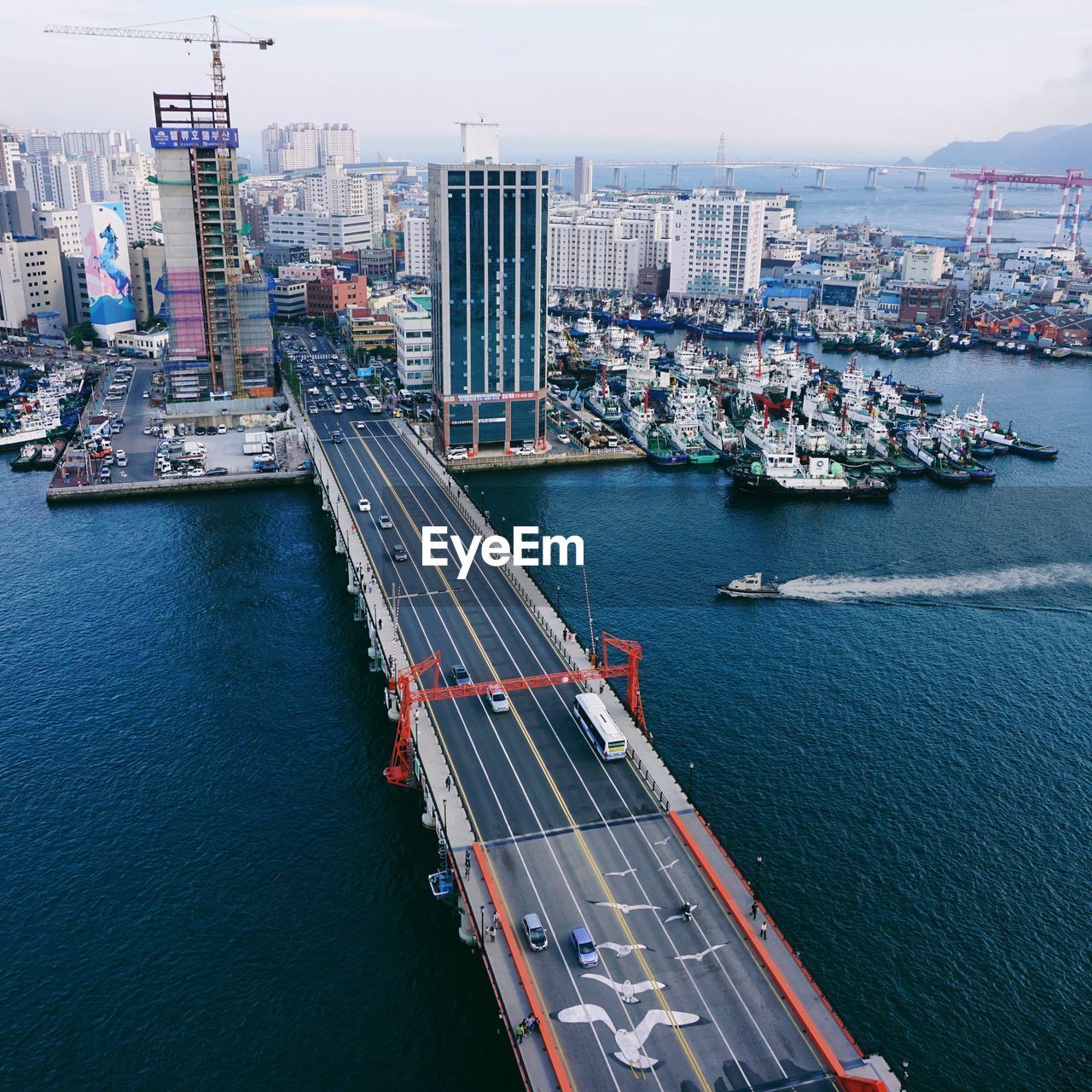 High angle view of buildings by sea against sky