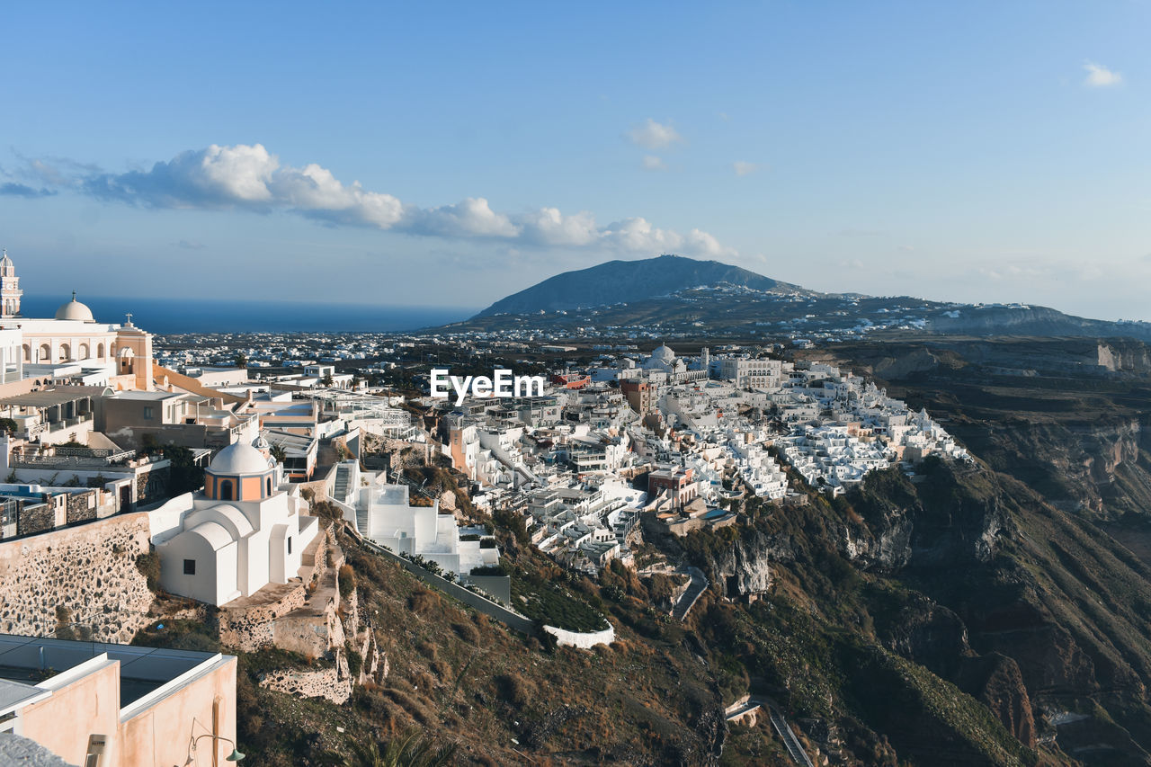 High angle view of townscape by sea against sky