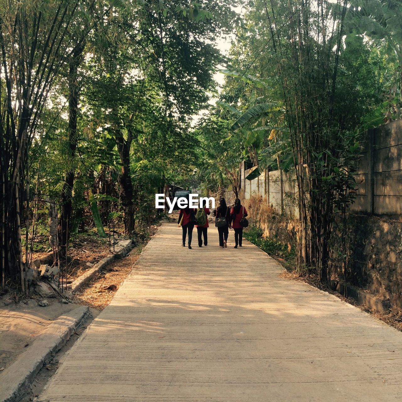 WOMAN WALKING ON FOOTPATH