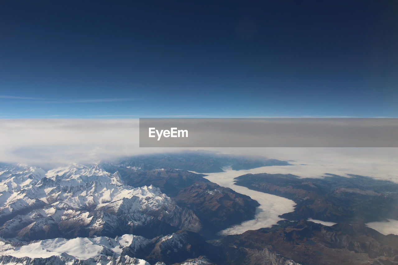 AERIAL VIEW OF MOUNTAINS AGAINST SKY