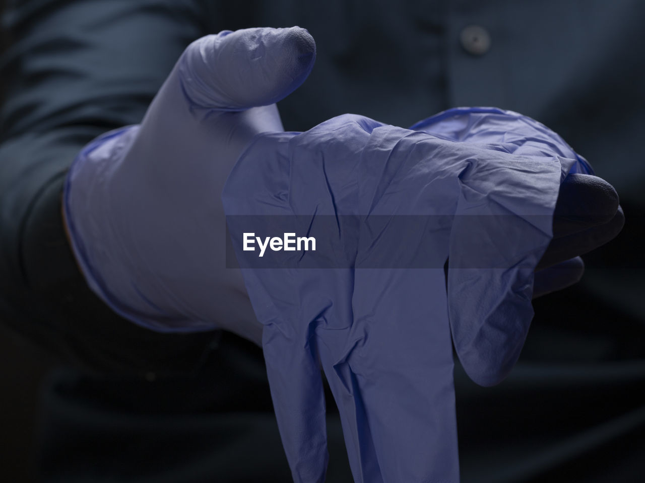 Midsection of man wearing gloves