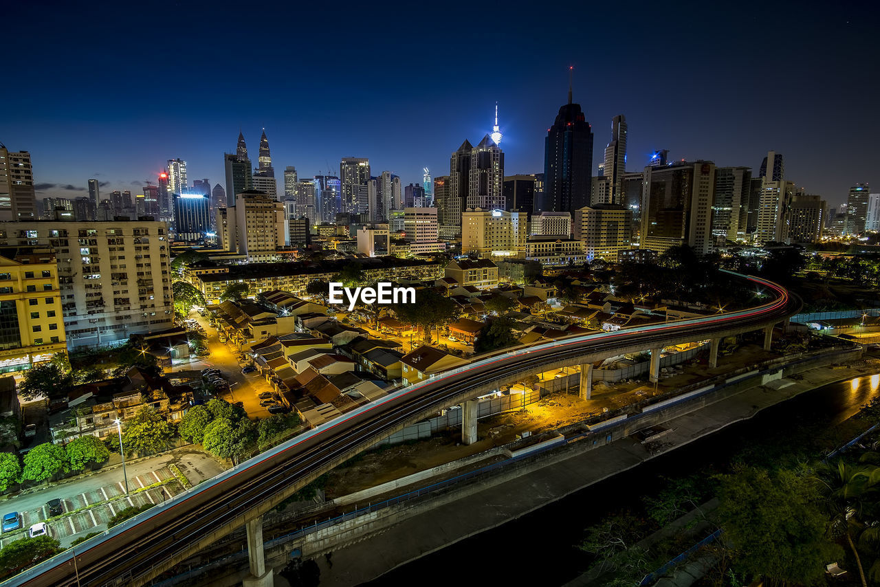 High angle view of city lit up at night