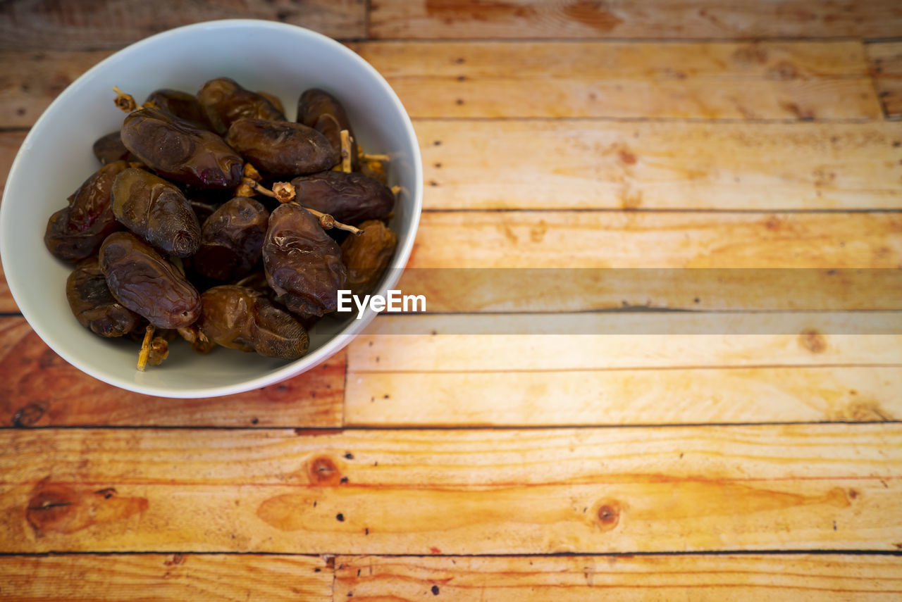 Dates fruits on wooden table. ramadan muslim concept.