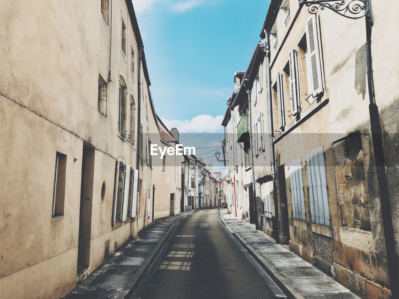 Empty alley amidst buildings in city