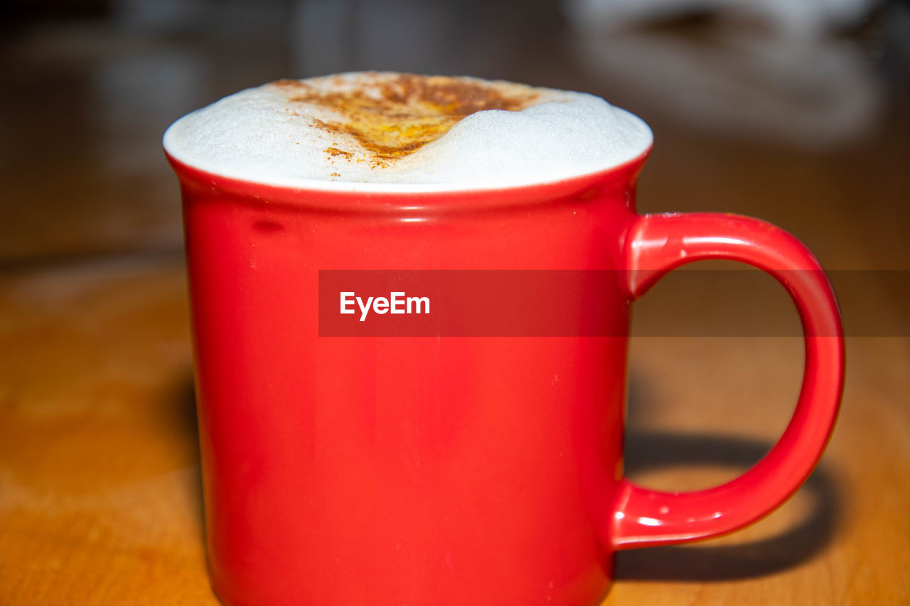 CLOSE-UP OF CUP OF COFFEE ON TABLE