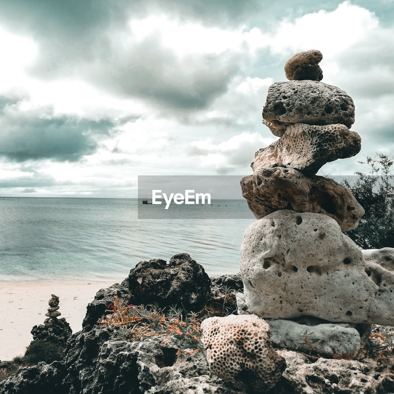 Rocks on sea shore against sky