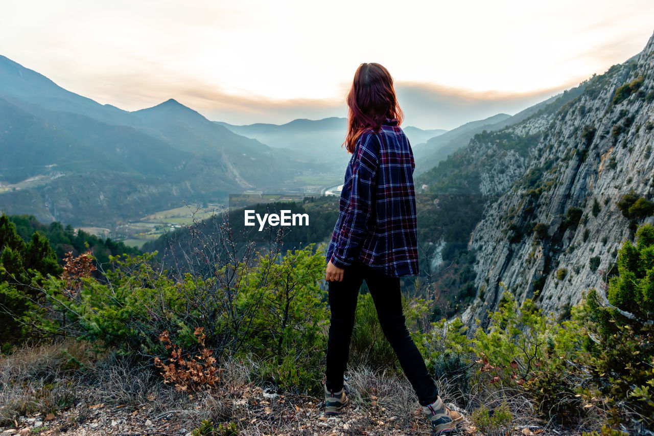 Full length of woman walking on mountain against sky