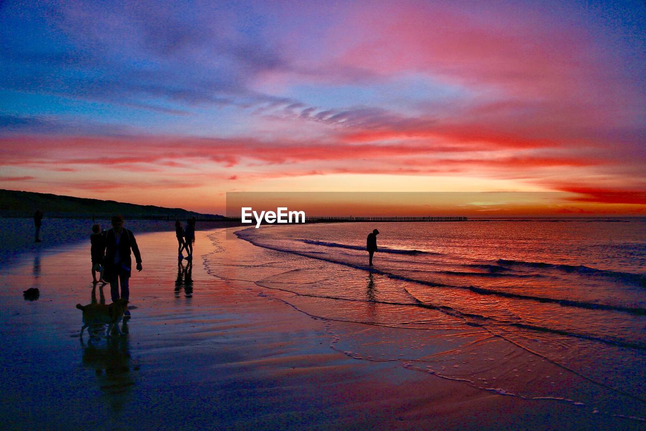 SCENIC VIEW OF BEACH DURING SUNSET