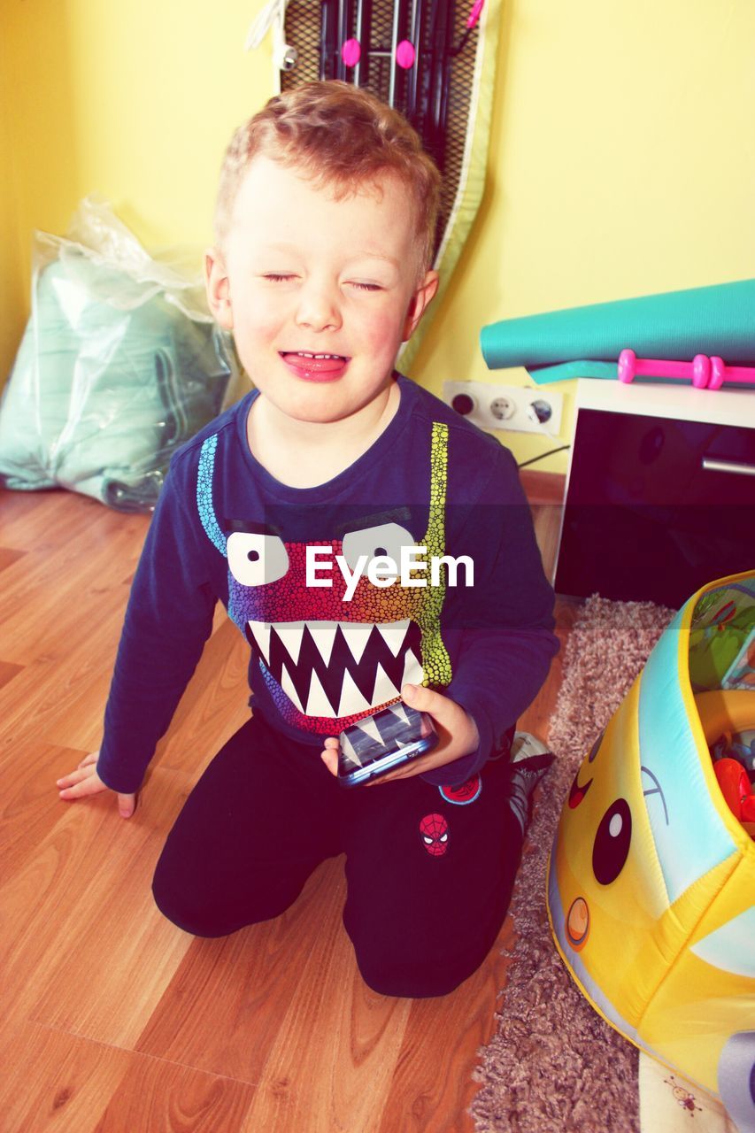 PORTRAIT OF BOY IN HOME