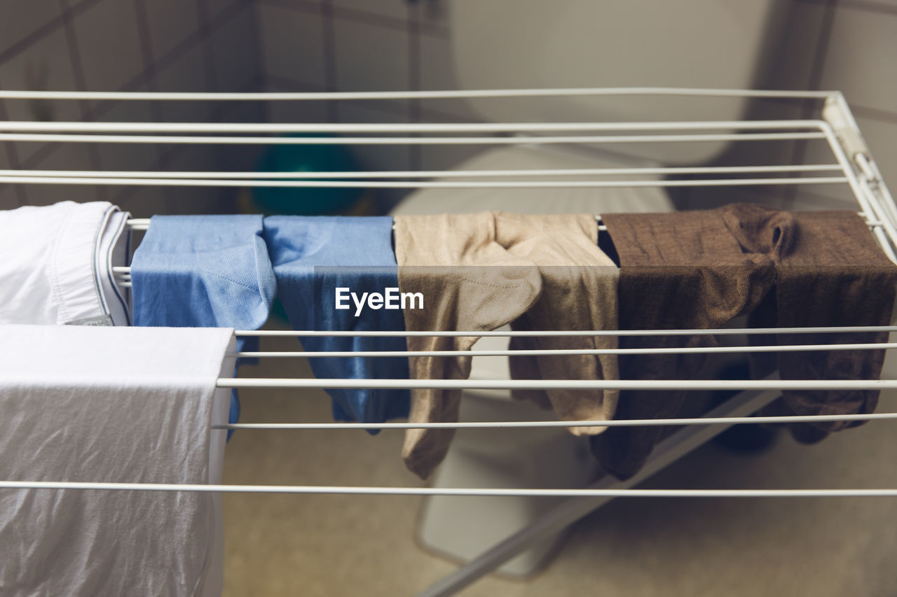 Close-up of clothes drying on rack