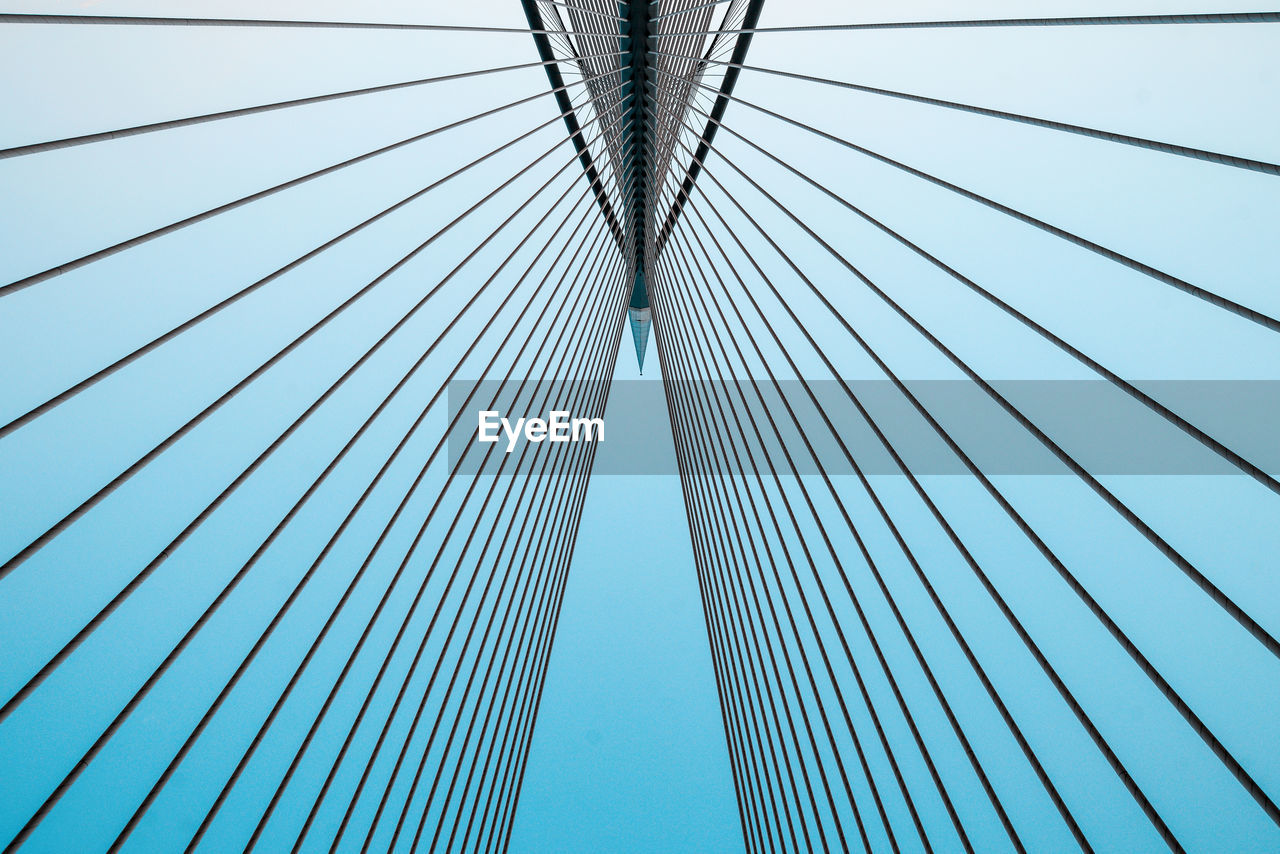 Low angle view of suspension bridge against sky