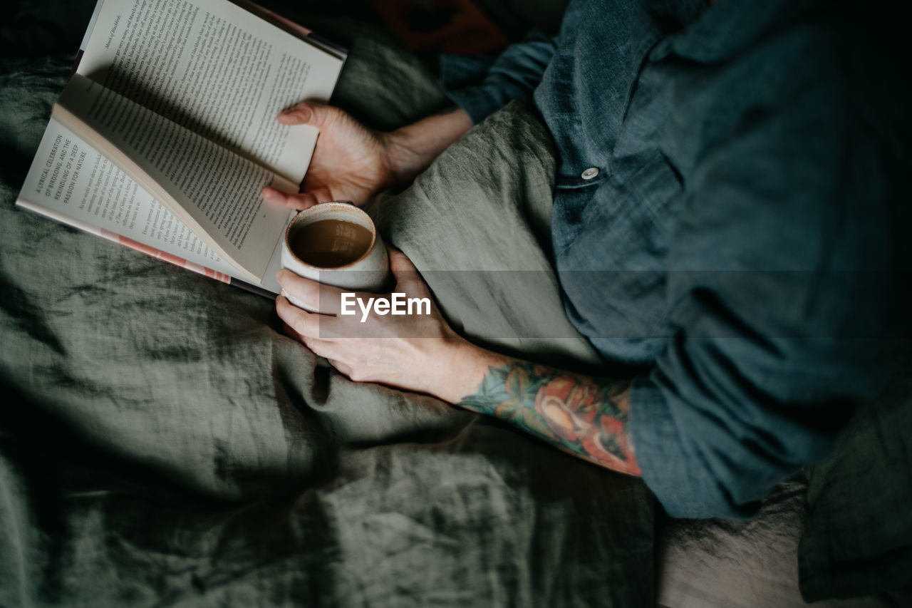 midsection of woman holding coffee cup