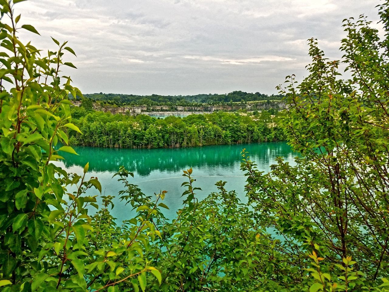 Scenic view of lake against cloudy sky