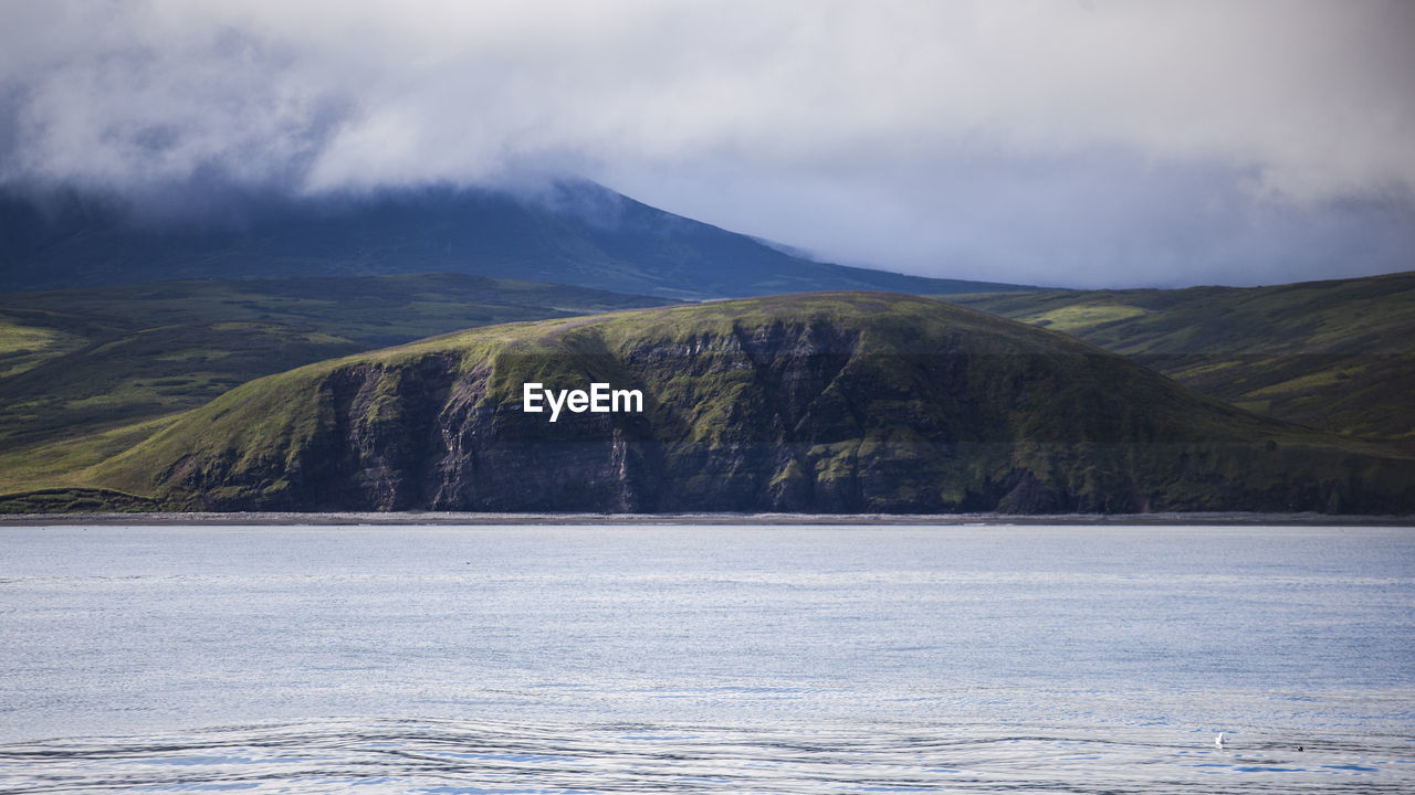 Scenic view of lake and mountains against sky