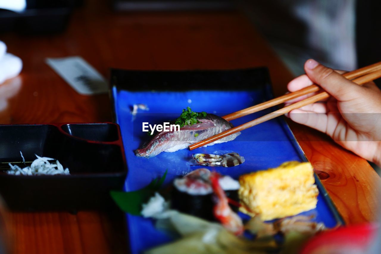 Midsection of person holding sushi