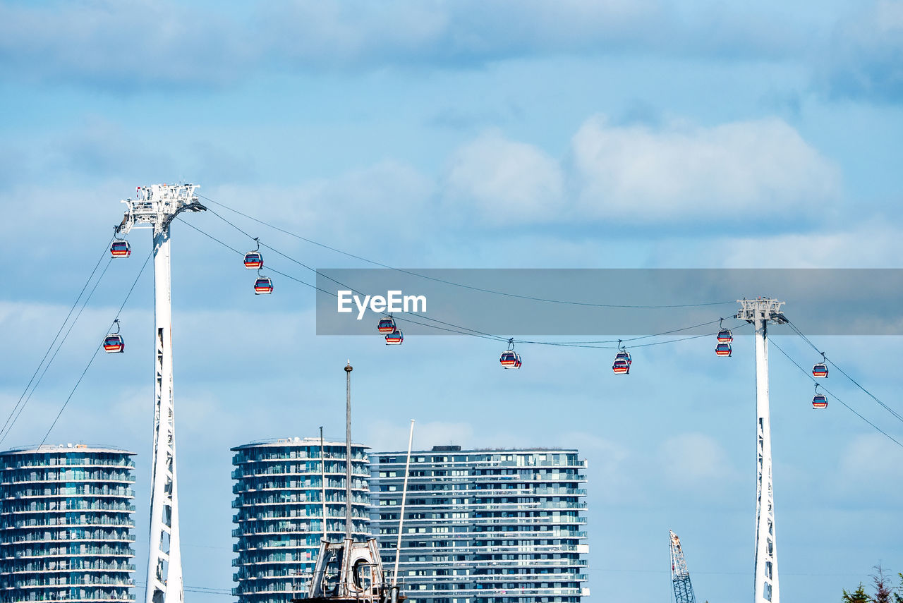 View of the emirates cable car in london england across river thames.