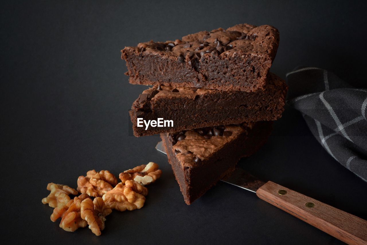 Close-up of chocolate fudge with walnut on table