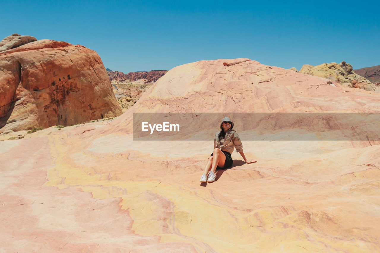 rear view of woman standing on rock formations