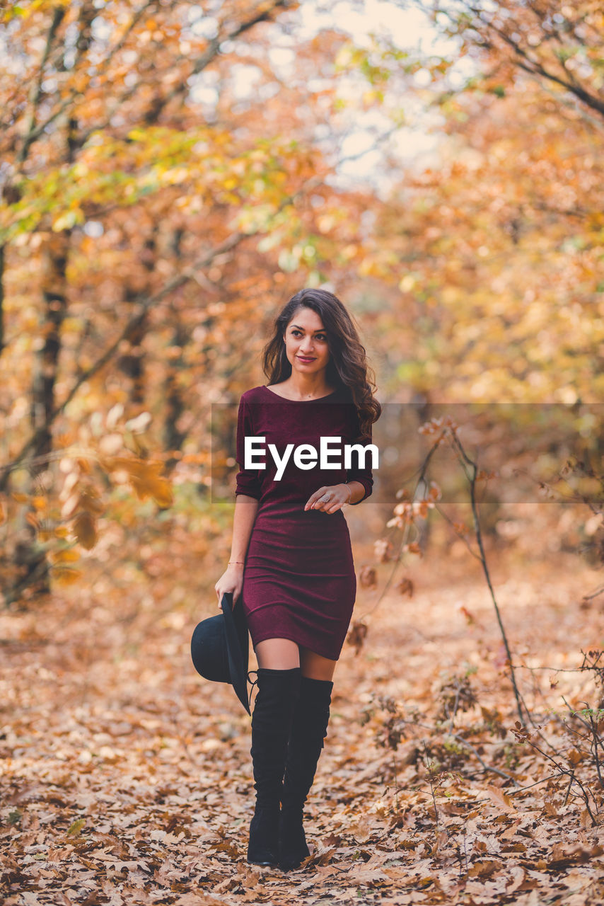 Portrait of a young woman standing in autumn