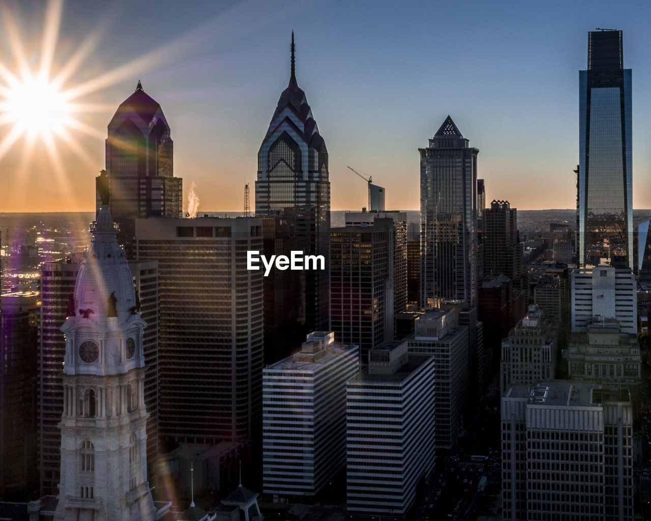 Skyscrapers in city against sky during sunset