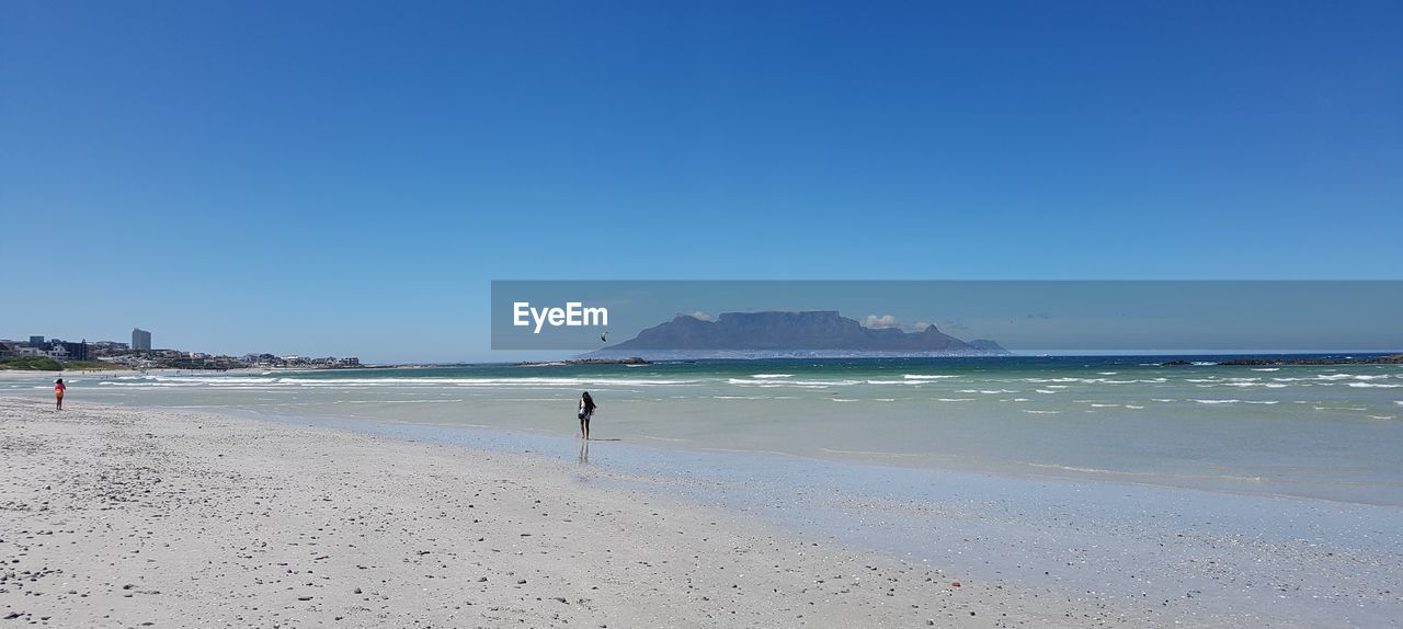 Adult Beach Beauty In Nature Blouberg Strand Blue Clear Sky Day Full Length Horizon Over Water Nature Outdoors People Sand Scenics Sea Sky South Africa 🇿🇦 Summer Table Mountain Tranquil Scene Tranquility Vacations Water Wave
