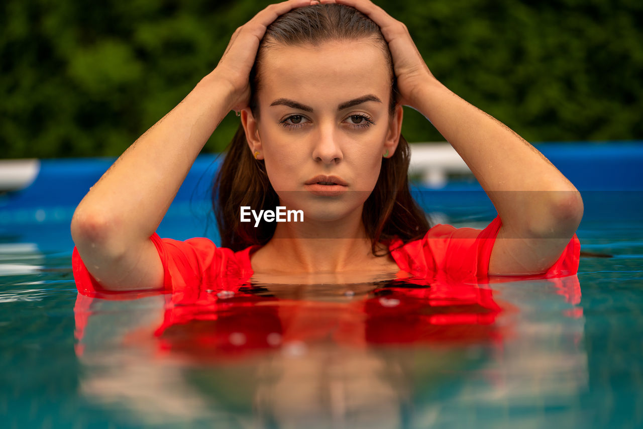 Portrait of a beautiful woman in the swimming pool.