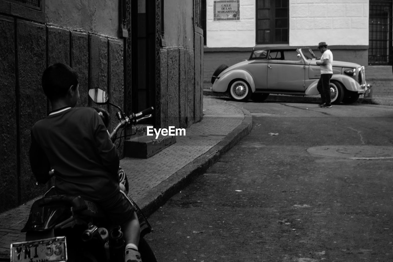 FULL LENGTH REAR VIEW OF A MAN ON MOTORCYCLE