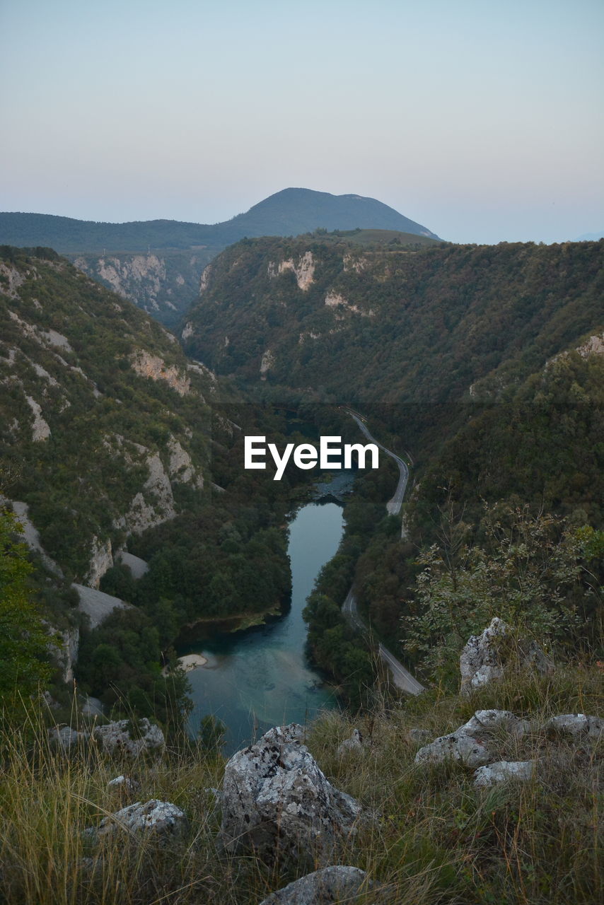 Scenic view of lake amidst mountains against sky