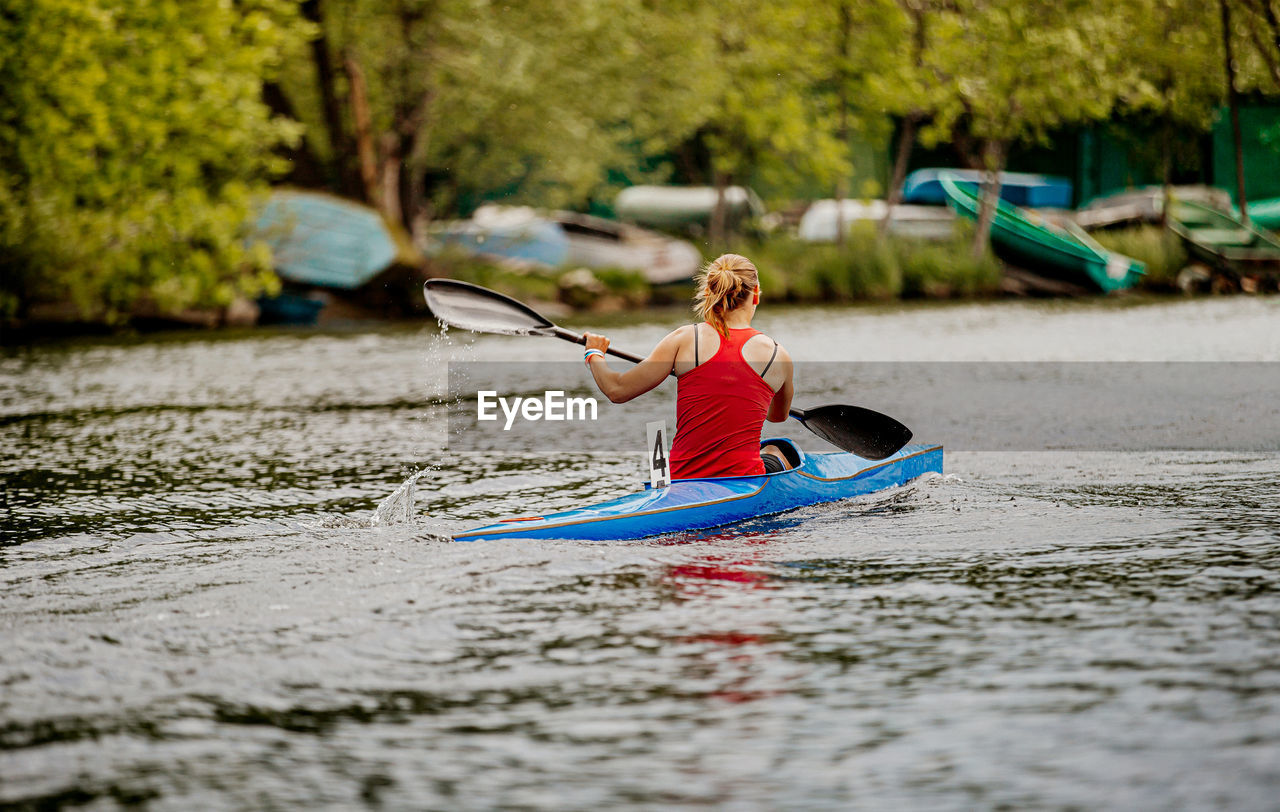 Full length of woman in boat on lake