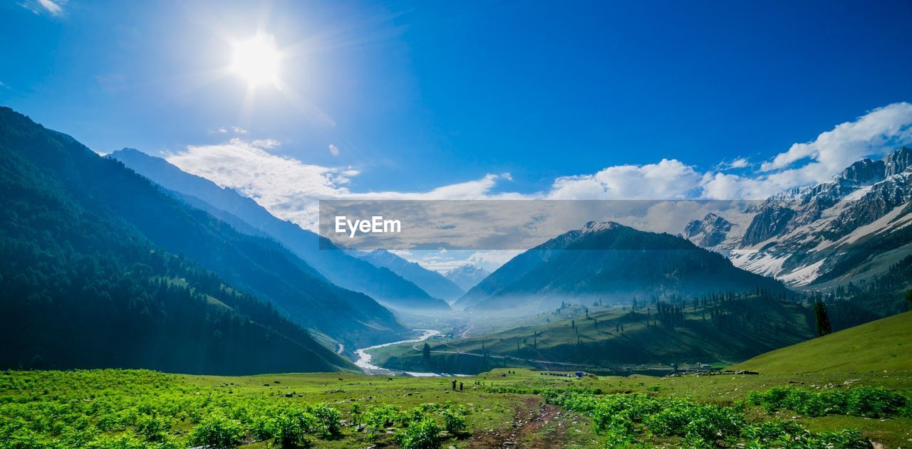 Scenic view of landscape against blue sky