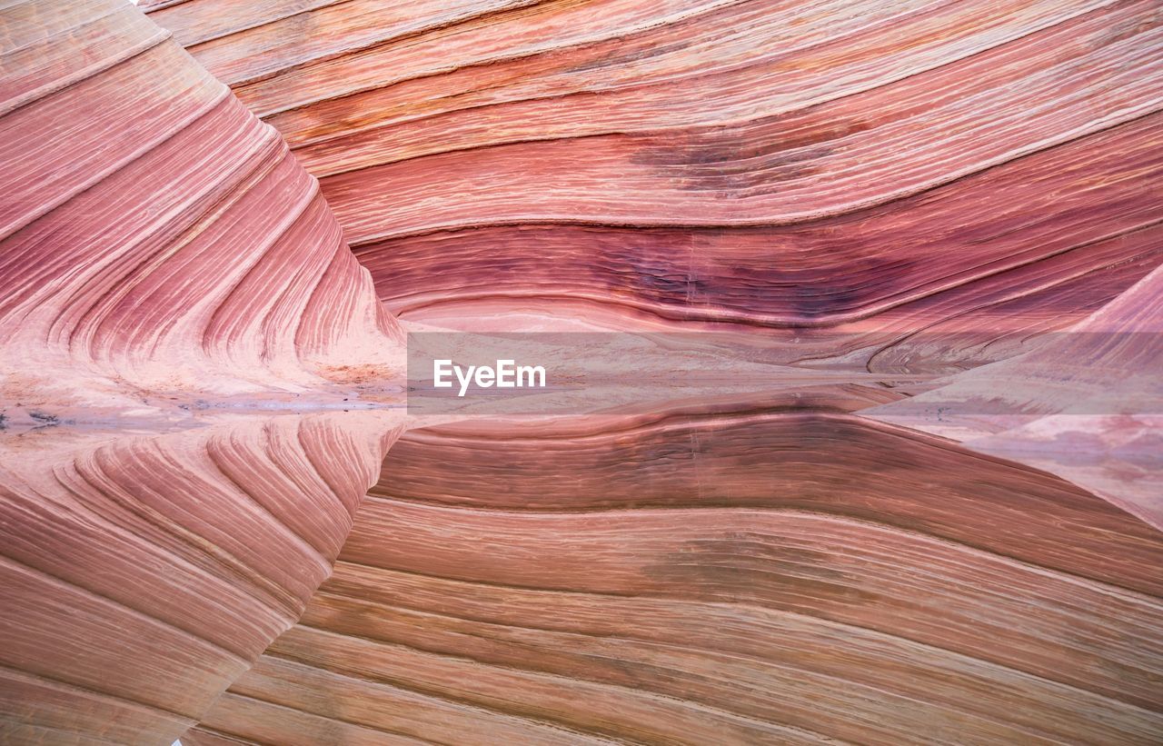 Reflection of rock formation in sea