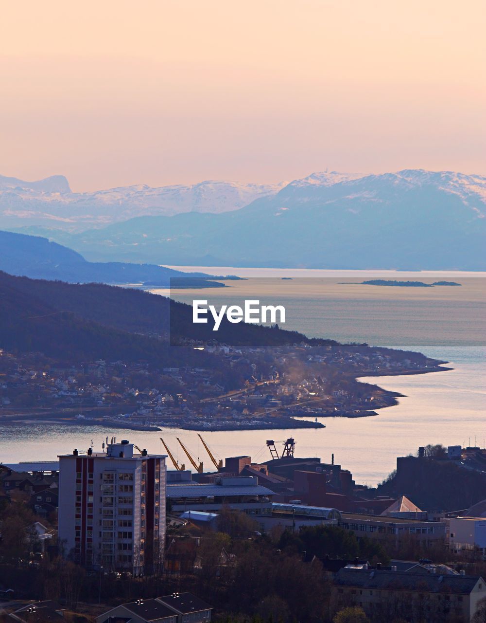 High angle view of buildings in city at sunset