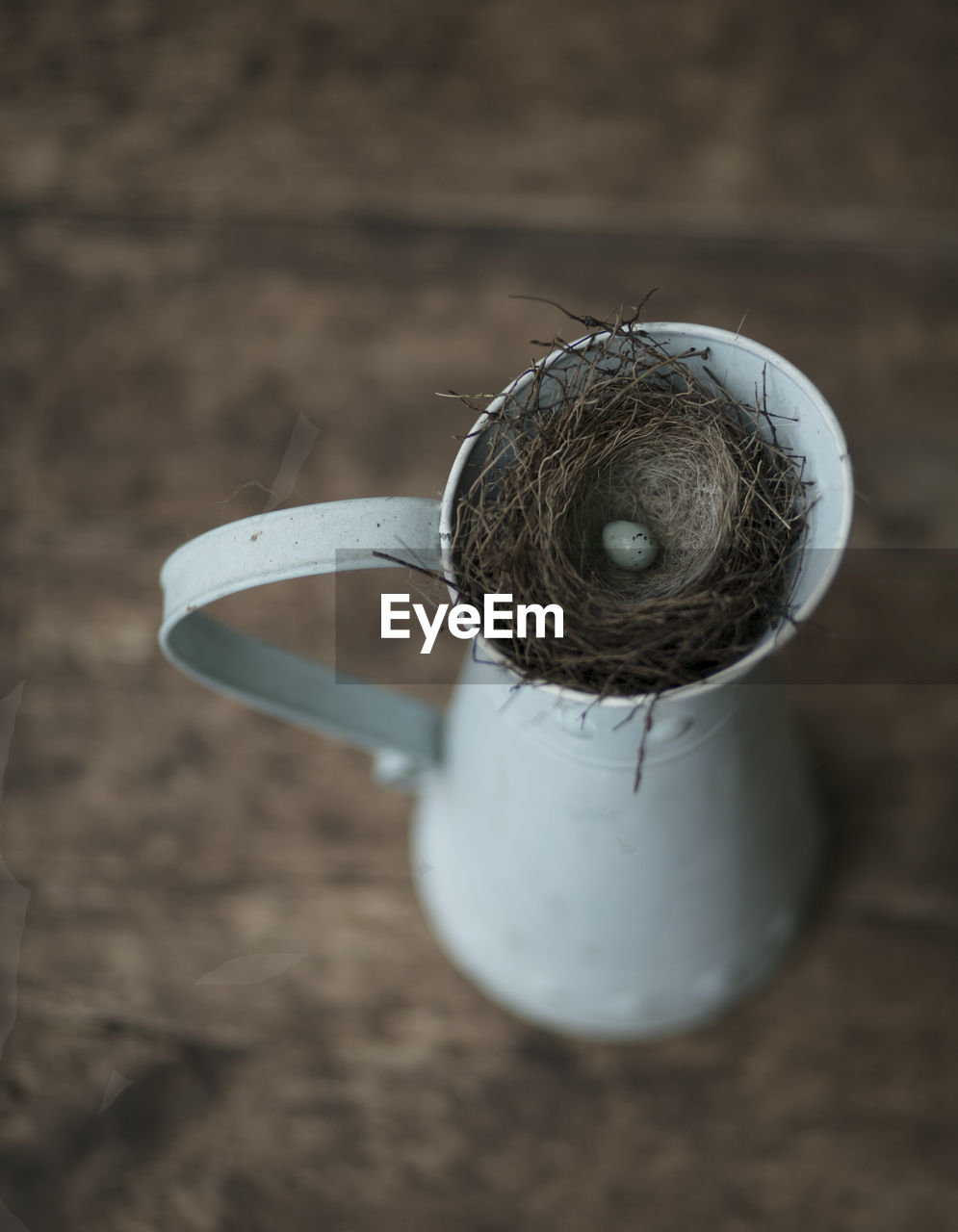 High angle view of egg in nest on jug