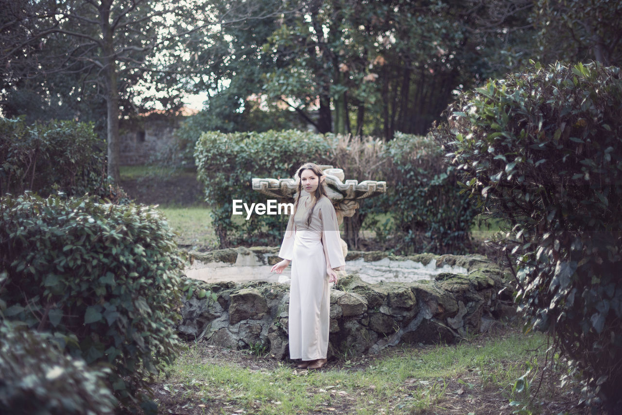 Portrait of fairy elf young woman standing at park