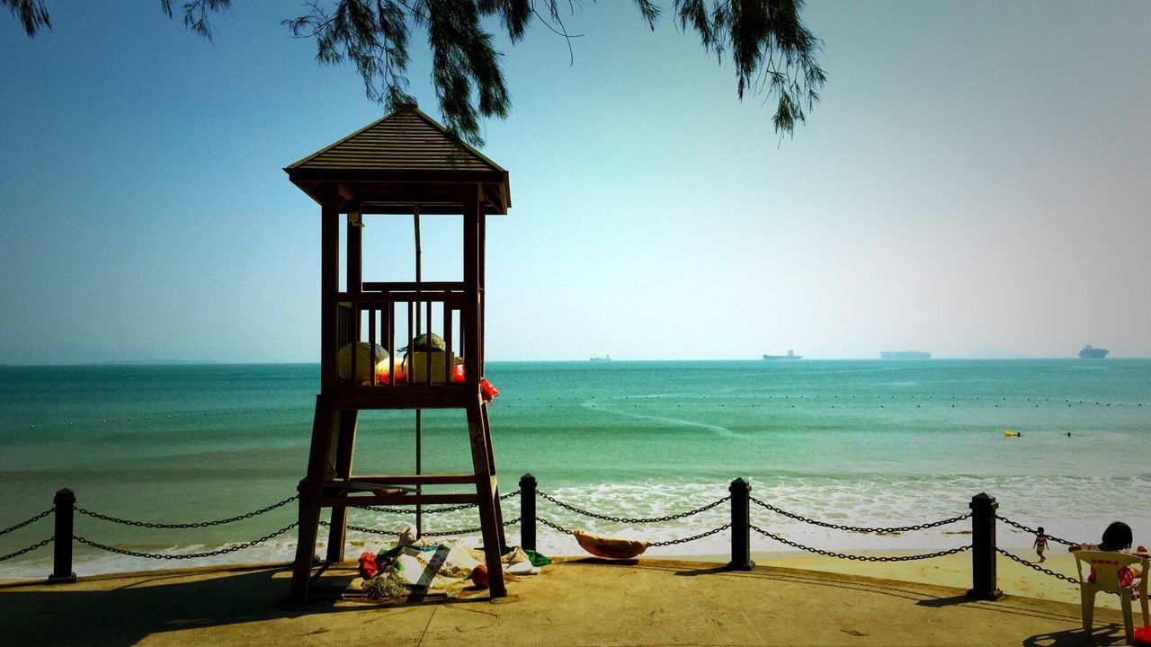 Lifeguard hut on beach against sky