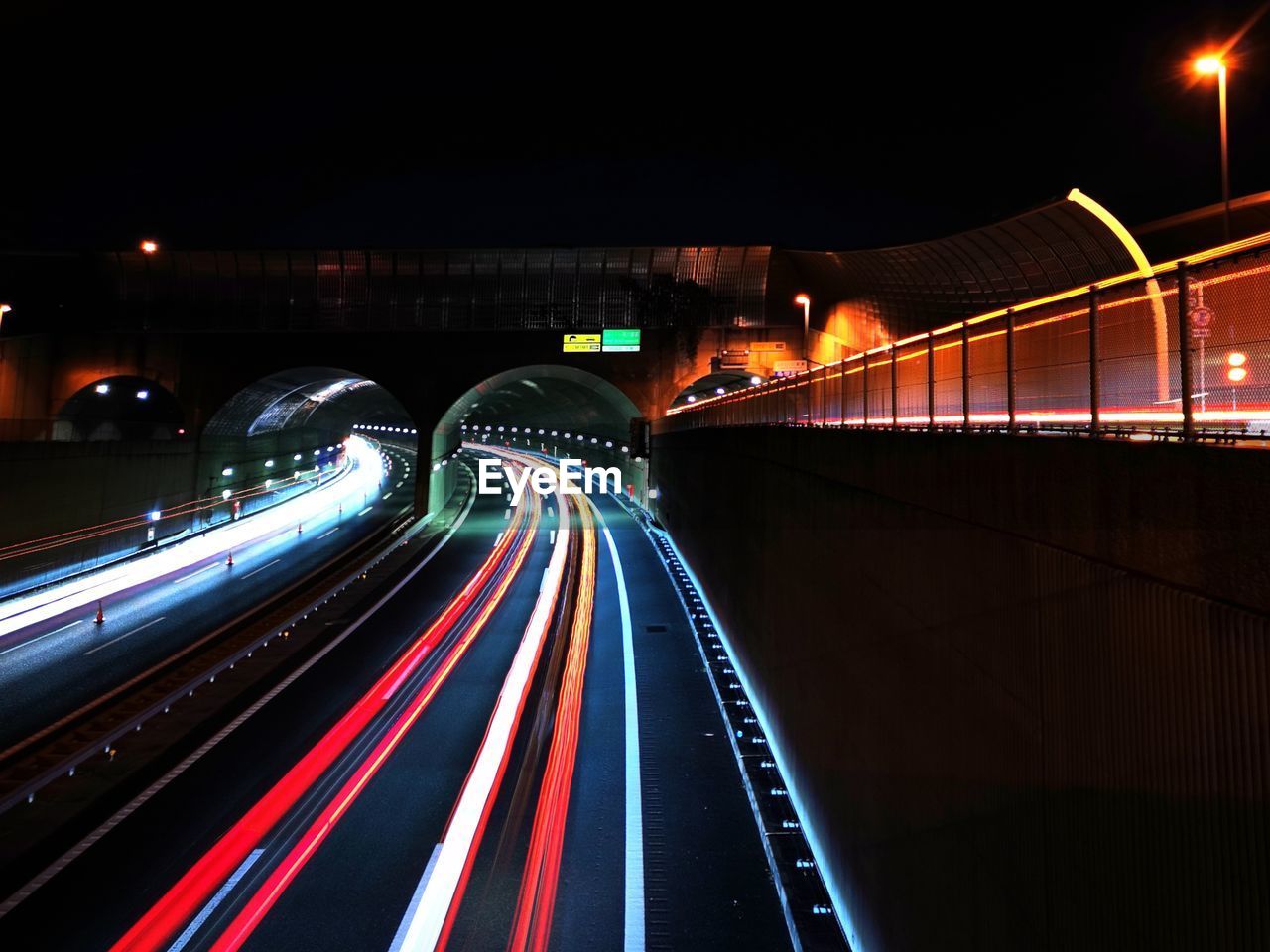 light trail, illuminated, night, transportation, long exposure, motion, speed, architecture, city, light, traffic, tail light, road, built structure, blurred motion, street, mode of transportation, city life, highway, darkness, building exterior, lighting equipment, no people, bridge, street light, travel destinations, headlight, travel, motor vehicle, on the move, light - natural phenomenon, infrastructure, car, outdoors, city street, the way forward, red, vehicle light, evening, multi colored, lane, nature, cityscape, multiple lane highway