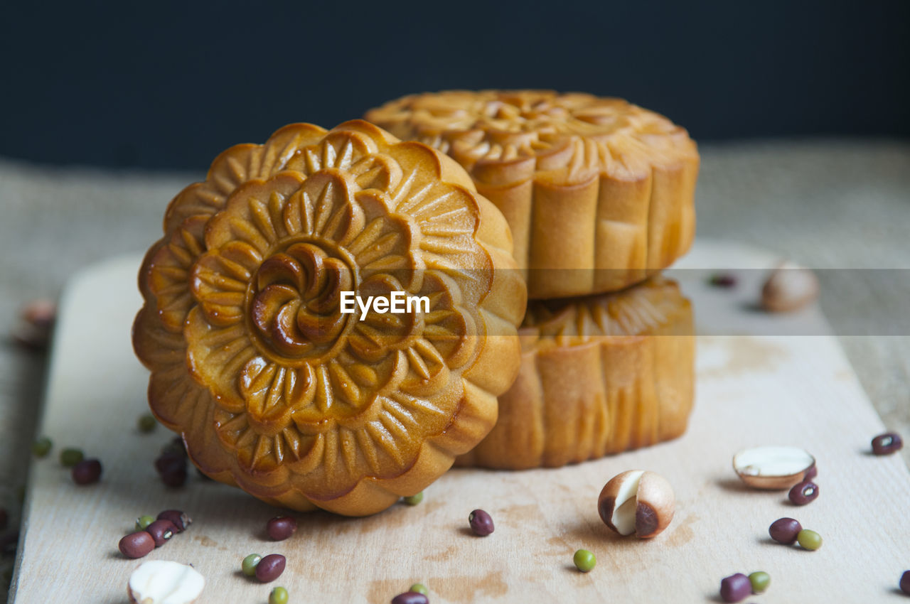 Close-up of moon cakes with seeds on cutting board