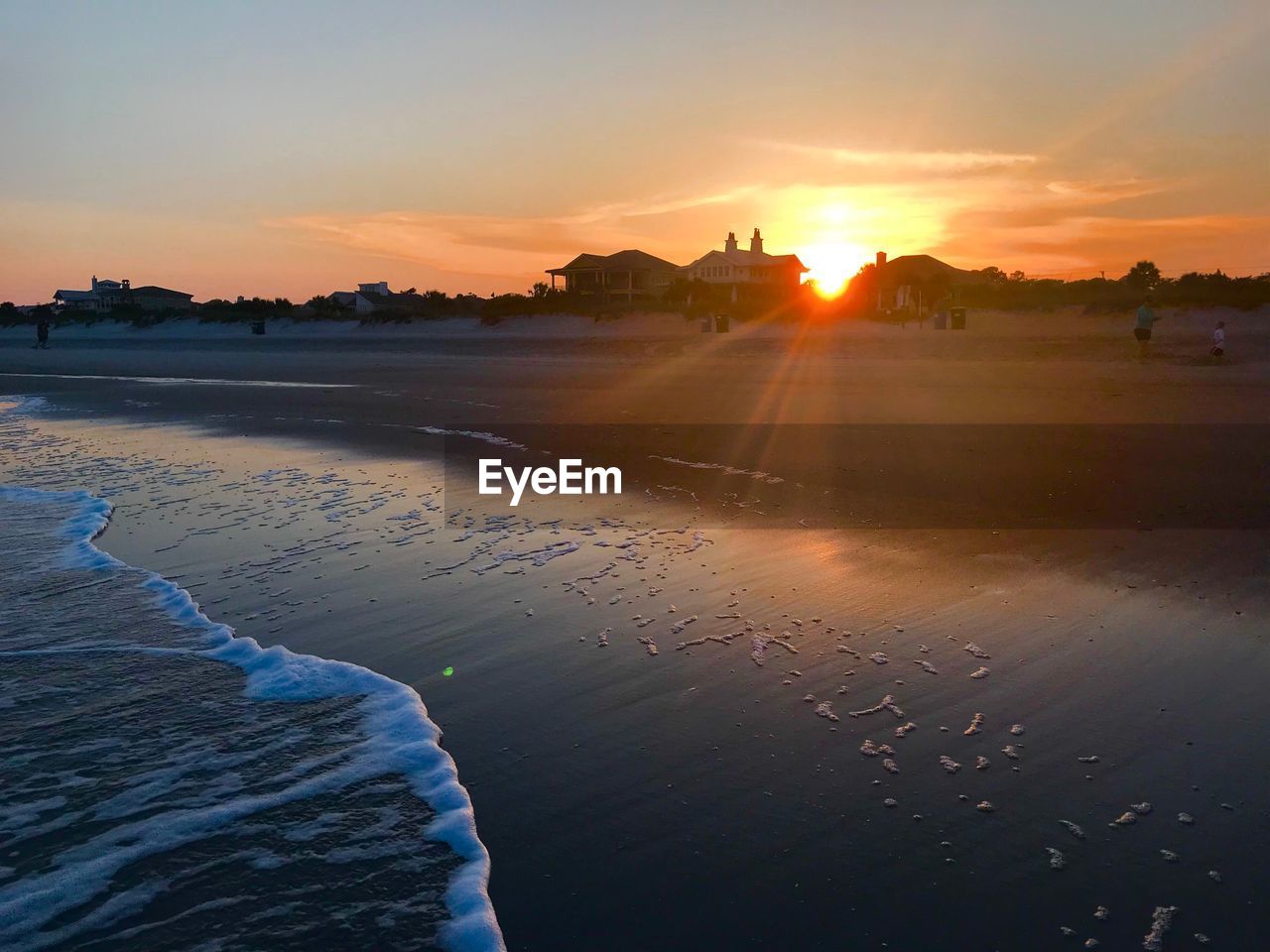 SCENIC VIEW OF BEACH AGAINST SKY AT SUNSET