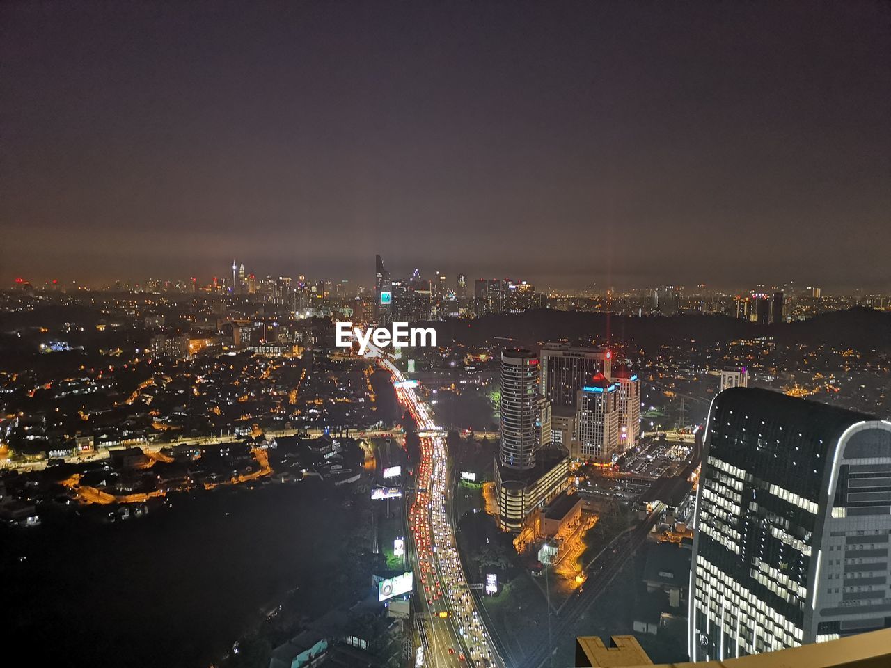 High angle view of illuminated buildings against sky at night