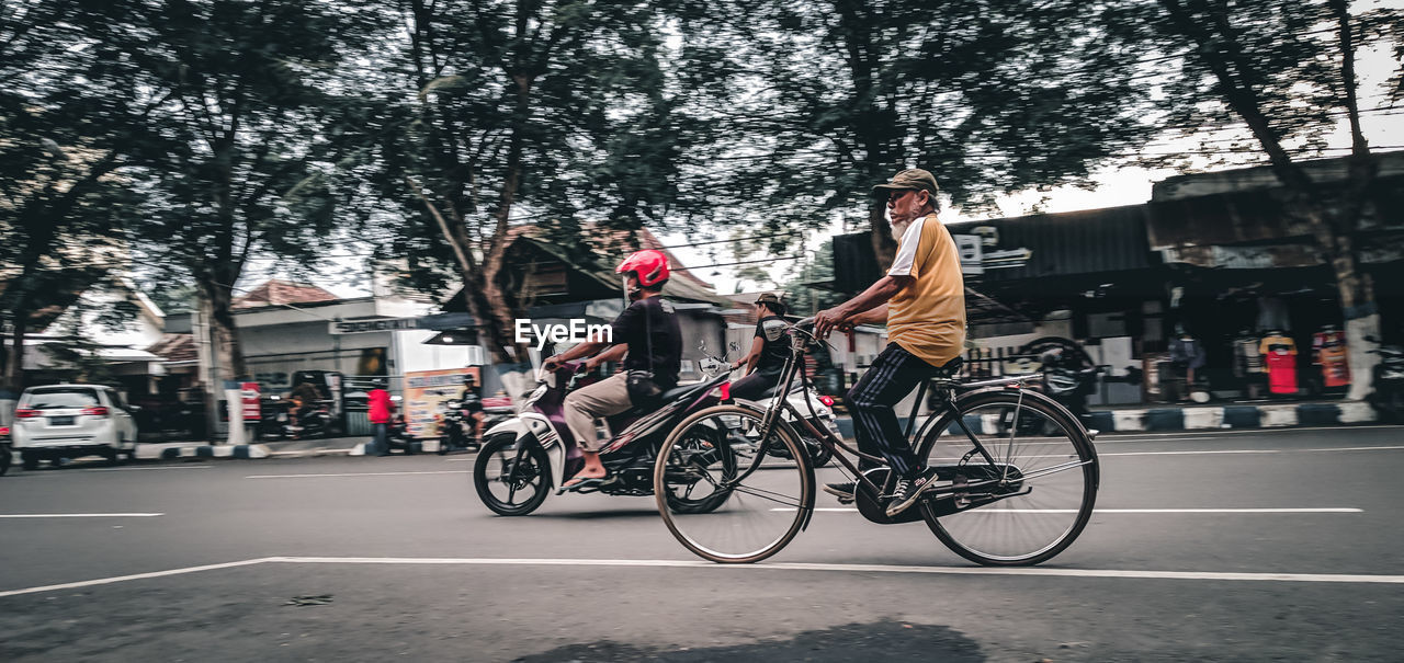 BICYCLES RIDING BICYCLE ON ROAD