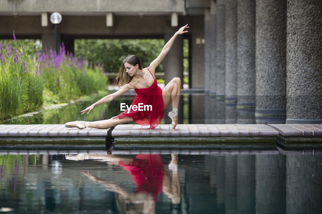 Woman ballet dancing at pond