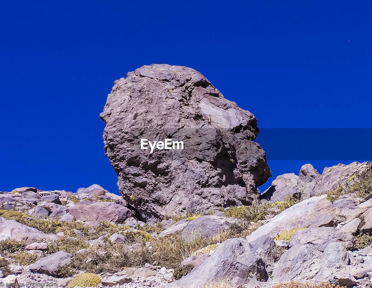 LOW ANGLE VIEW OF ROCKS AGAINST BLUE SKY