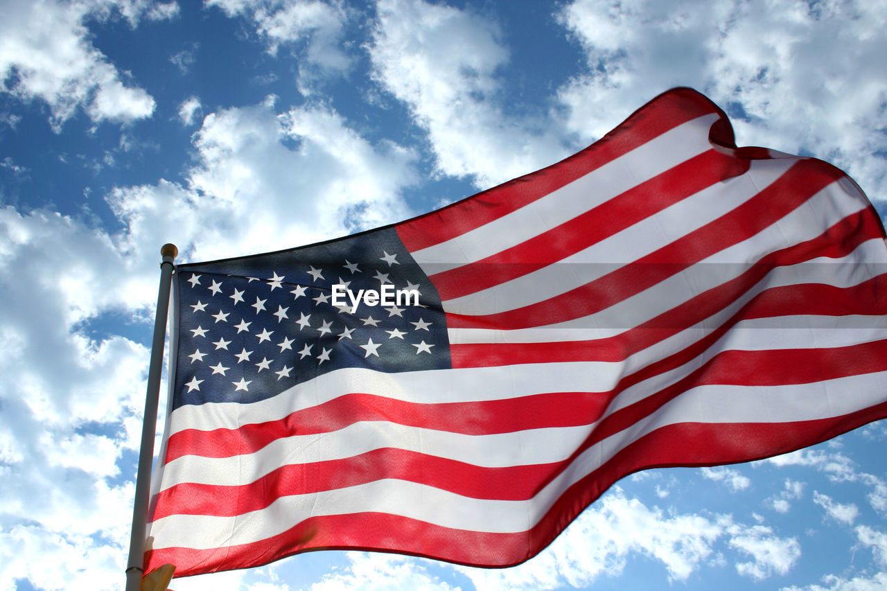 Low angle view of american flag against sky