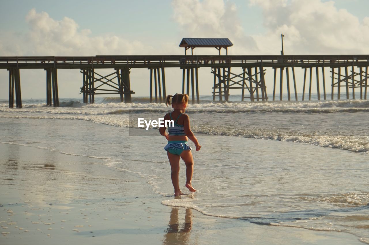 WOMAN STANDING ON PIER